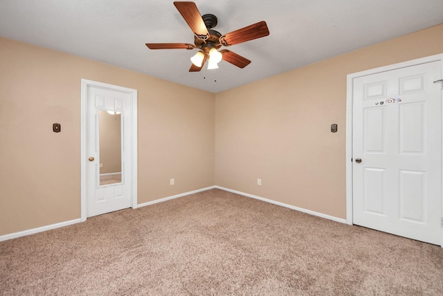 unfurnished room with carpet, baseboards, and a ceiling fan