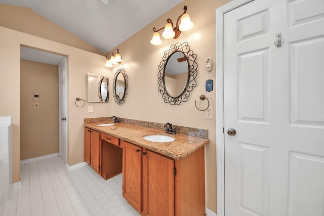 full bath featuring lofted ceiling, tile patterned flooring, double vanity, and a sink