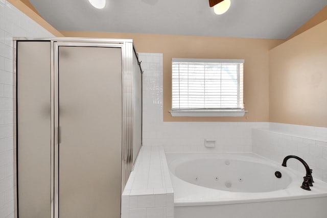 bathroom featuring a whirlpool tub and a stall shower