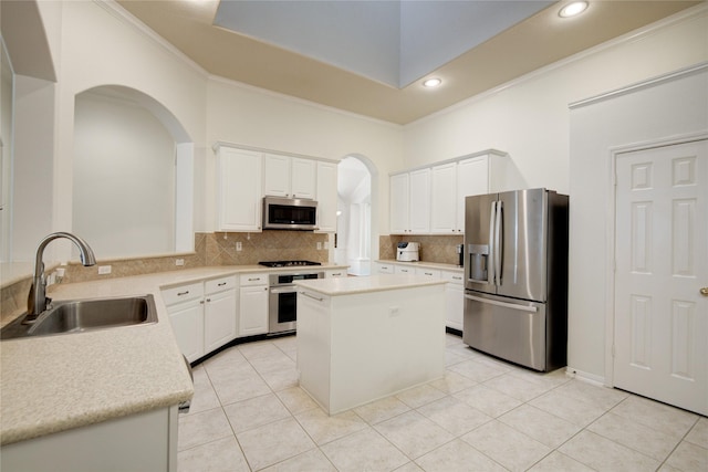 kitchen with appliances with stainless steel finishes, a sink, light countertops, crown molding, and backsplash