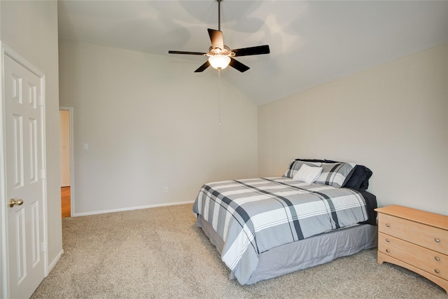 carpeted bedroom featuring lofted ceiling, baseboards, and a ceiling fan