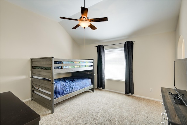 bedroom featuring carpet floors, baseboards, vaulted ceiling, and a ceiling fan