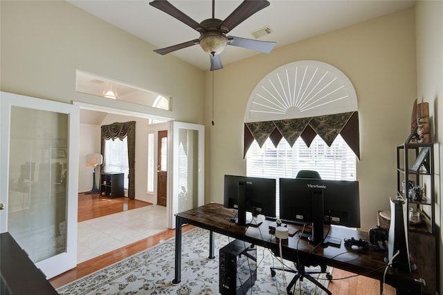 tiled office with french doors, visible vents, and ceiling fan