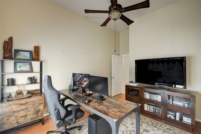 home office featuring vaulted ceiling, ceiling fan, and wood finished floors