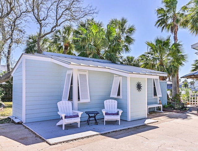 exterior space with metal roof and a deck