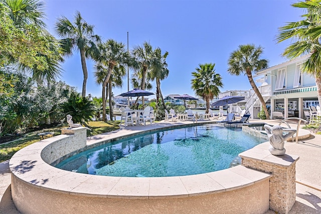 view of pool with a pool with connected hot tub and a patio