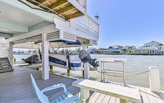 view of dock featuring a residential view, a water view, and boat lift