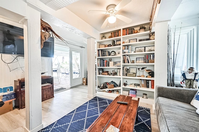 living area with ceiling fan and wood finished floors