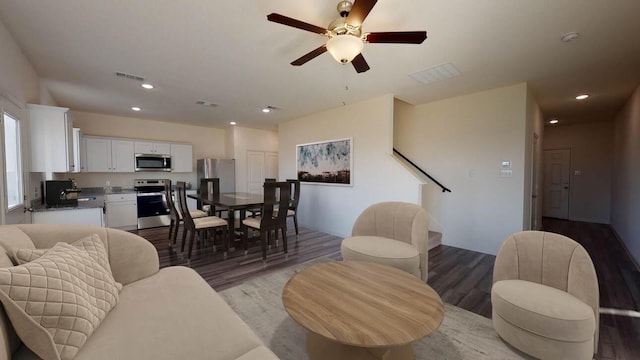 living room with ceiling fan, visible vents, wood finished floors, and recessed lighting