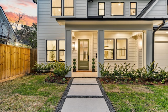 property entrance with a yard and fence