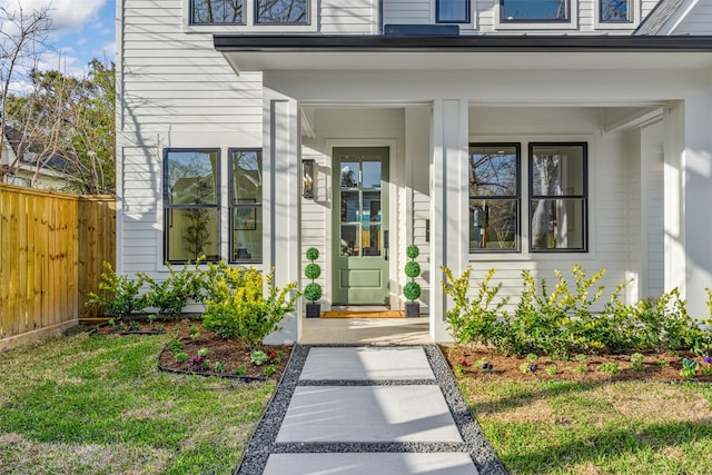 203 Munford St, Houston, TX 77008 - doorway to property featuring covered porch, fence, and a lawn