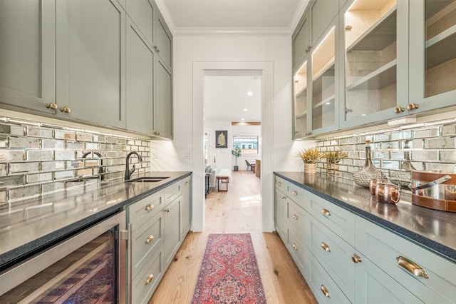203 Munford St, Houston, TX 77008 - bar featuring light wood finished floors, beverage cooler, backsplash, and a sink