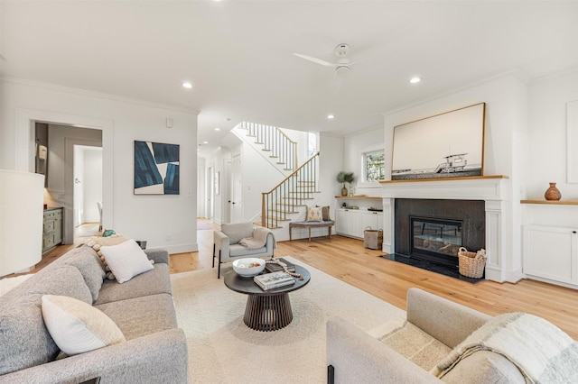 203 Munford St, Houston, TX 77008 - living area featuring light wood finished floors, ornamental molding, and a fireplace with flush hearth