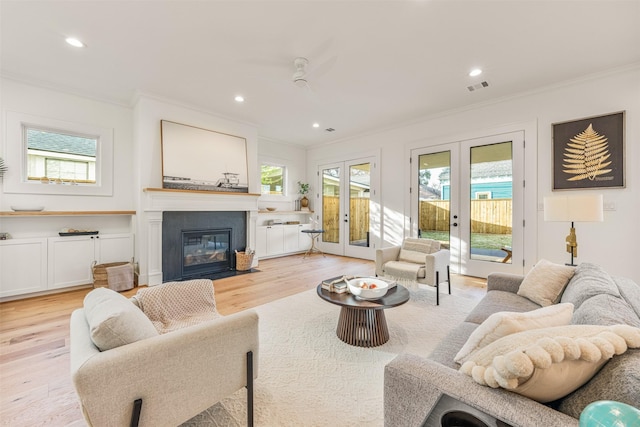 203 Munford St, Houston, TX 77008 - living room featuring french doors, ornamental molding, visible vents, a ceiling fan, and light wood-style floors