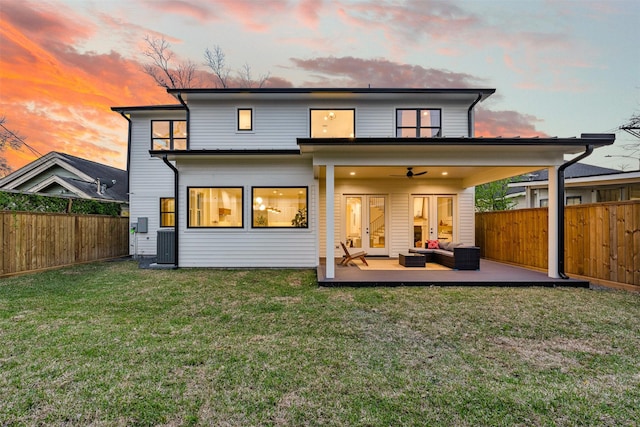 203 Munford St, Houston, TX 77008 - back of house with a fenced backyard, outdoor lounge area, a ceiling fan, and a yard