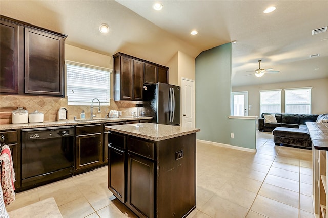 kitchen featuring visible vents, dishwasher, freestanding refrigerator, a ceiling fan, and a sink