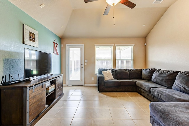 living room with light tile patterned floors, a healthy amount of sunlight, a ceiling fan, and vaulted ceiling