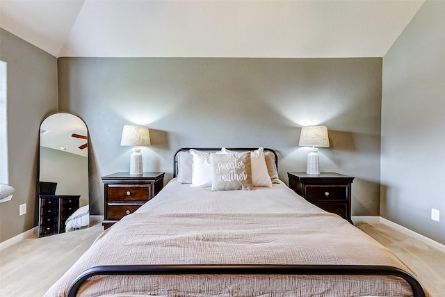 bedroom with lofted ceiling, baseboards, and carpet floors