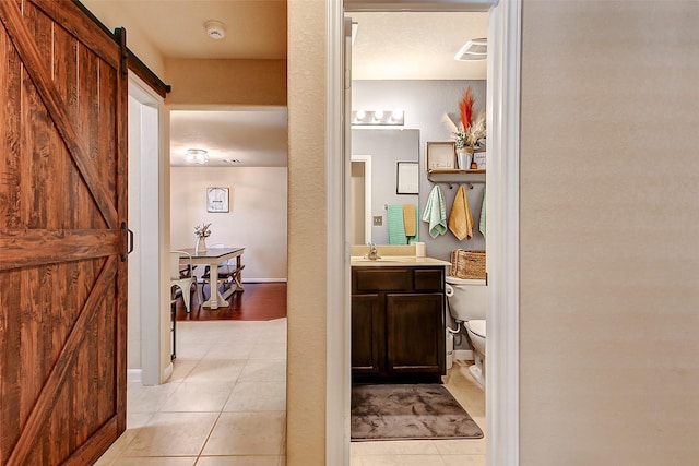 bathroom with vanity, tile patterned floors, toilet, and visible vents