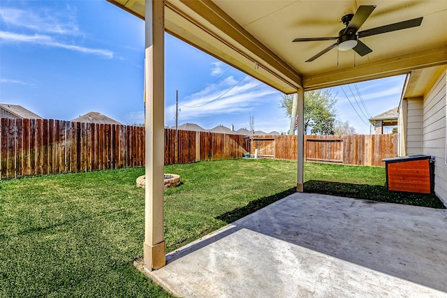 view of yard with a fenced backyard, a ceiling fan, and a patio