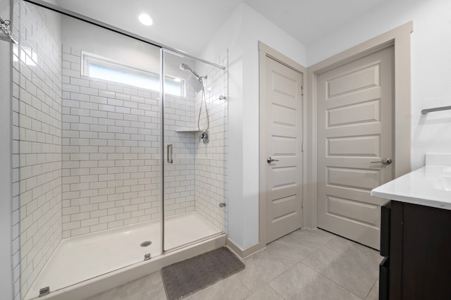 bathroom with a stall shower, vanity, and tile patterned floors