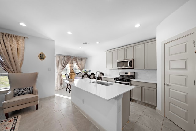 kitchen with light tile patterned floors, a sink, visible vents, appliances with stainless steel finishes, and gray cabinets