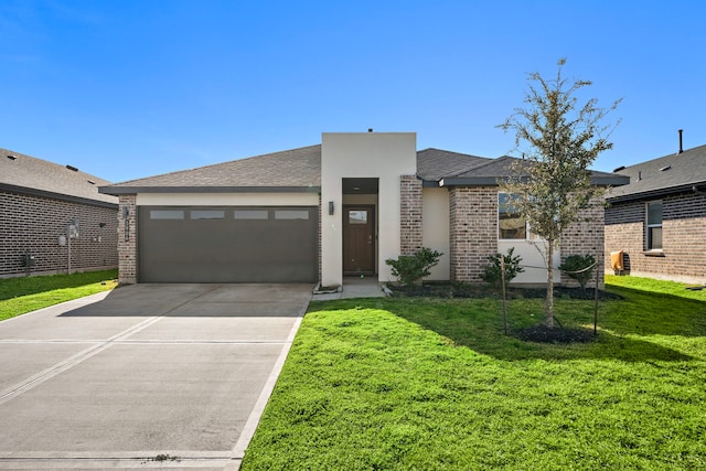 view of front of property with a front yard, concrete driveway, an attached garage, and stucco siding