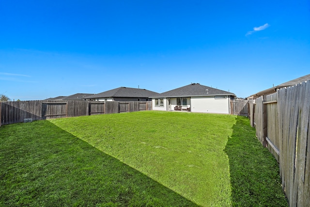 view of yard with a fenced backyard