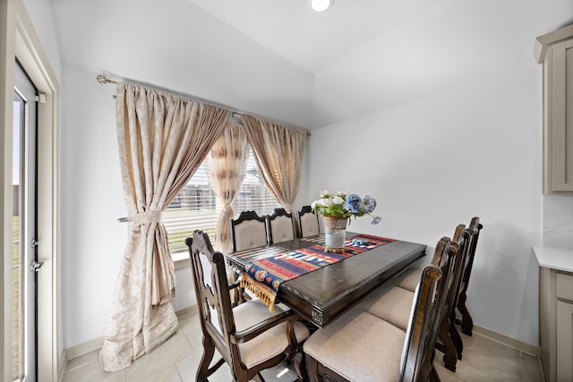 dining room featuring light tile patterned flooring and baseboards