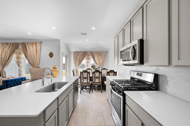 kitchen with visible vents, appliances with stainless steel finishes, gray cabinets, light countertops, and a sink