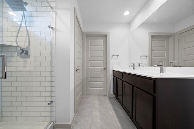 full bathroom with tile patterned flooring, recessed lighting, a sink, tiled shower, and double vanity