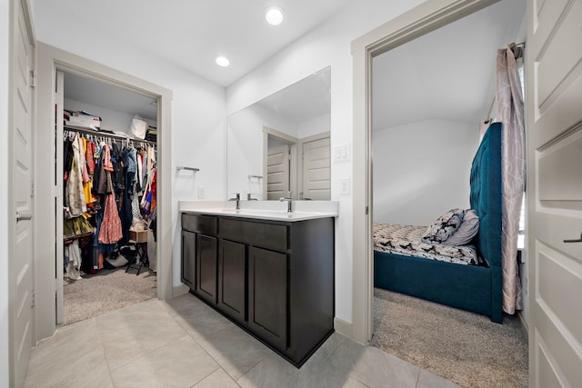 bathroom featuring a spacious closet, recessed lighting, vanity, and tile patterned floors