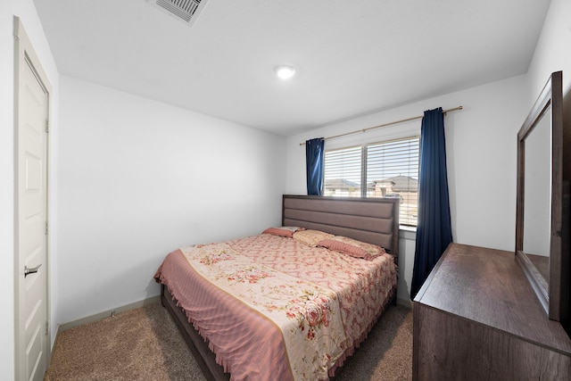 bedroom with carpet, visible vents, and baseboards