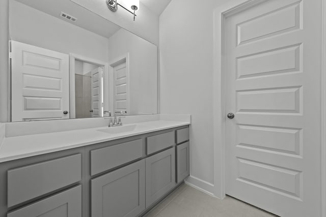 bathroom with tile patterned flooring, visible vents, baseboards, and vanity