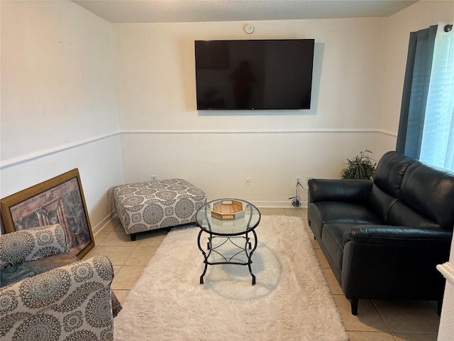 living room featuring baseboards and tile patterned floors