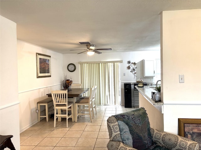 dining space featuring light tile patterned floors, ceiling fan, and visible vents