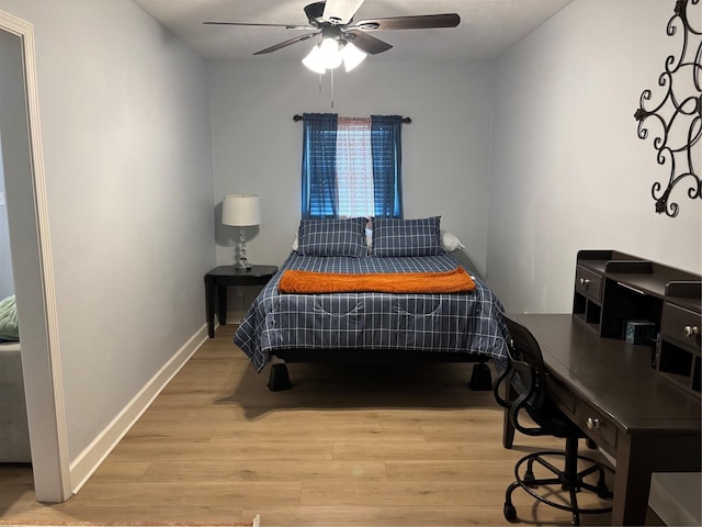 bedroom featuring ceiling fan, baseboards, and wood finished floors