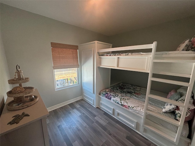 bedroom featuring dark wood-type flooring and baseboards