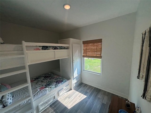 unfurnished bedroom featuring dark wood-style flooring and baseboards