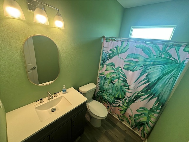 full bath featuring toilet, a shower with curtain, wood finished floors, and vanity