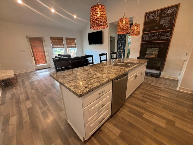 kitchen with a center island with sink, dark wood-type flooring, stainless steel dishwasher, white cabinetry, and a sink