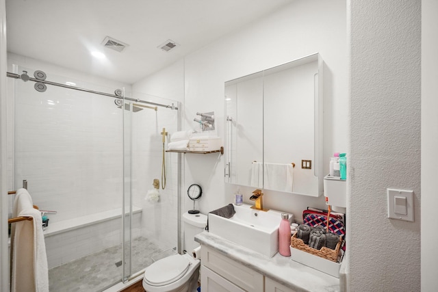 bathroom featuring visible vents, toilet, a shower stall, and vanity