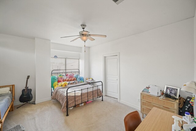 bedroom featuring light carpet, ceiling fan, and baseboards