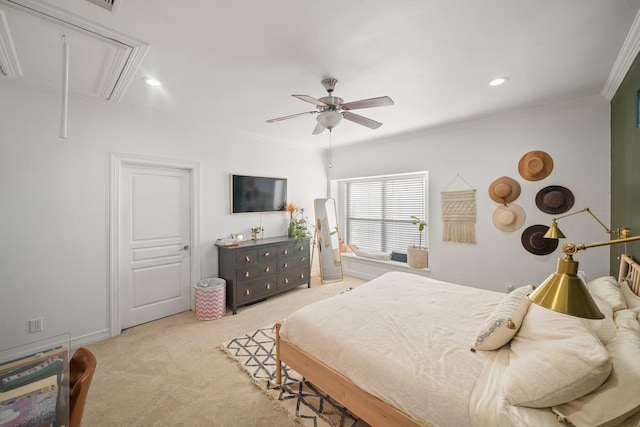 bedroom with crown molding, attic access, and light colored carpet