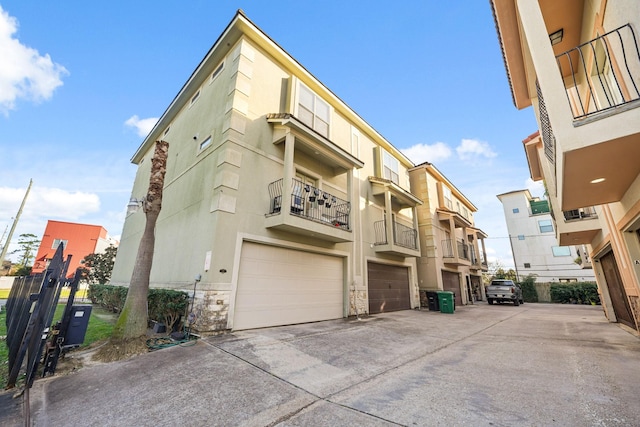 view of building exterior featuring driveway and an attached garage