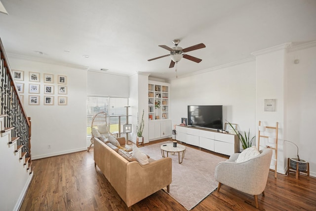 living room featuring ceiling fan, stairs, baseboards, and wood finished floors