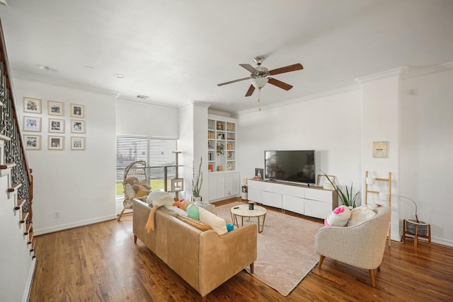 living room featuring baseboards, stairway, and wood finished floors