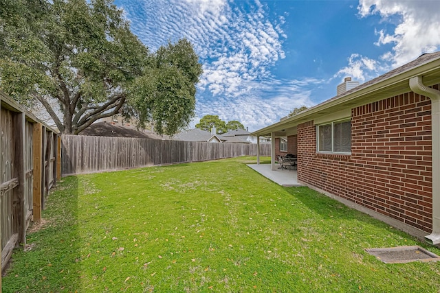 view of yard with a fenced backyard and a patio