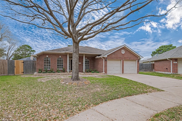 ranch-style house with brick siding, concrete driveway, an attached garage, fence, and a front lawn