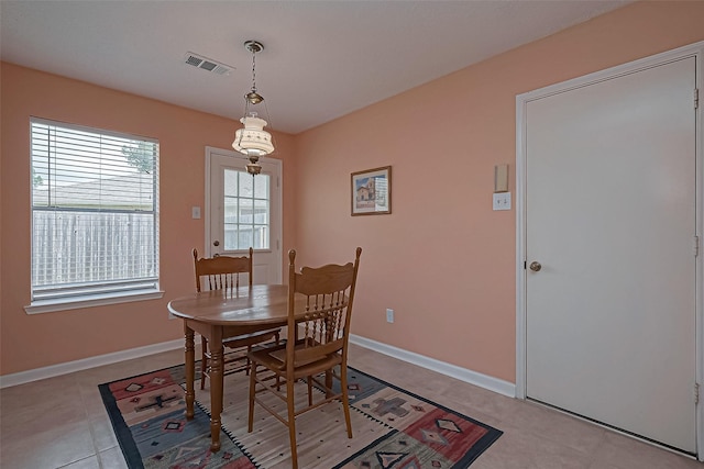 dining room with baseboards, visible vents, and light tile patterned flooring